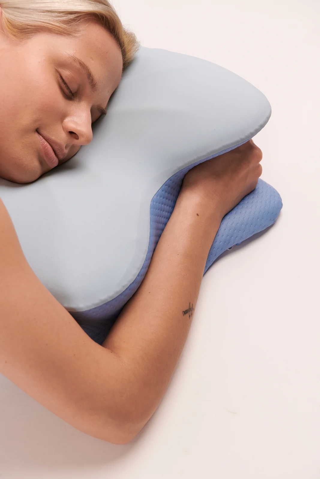 Stomach sleeping position with the pillow profile visible