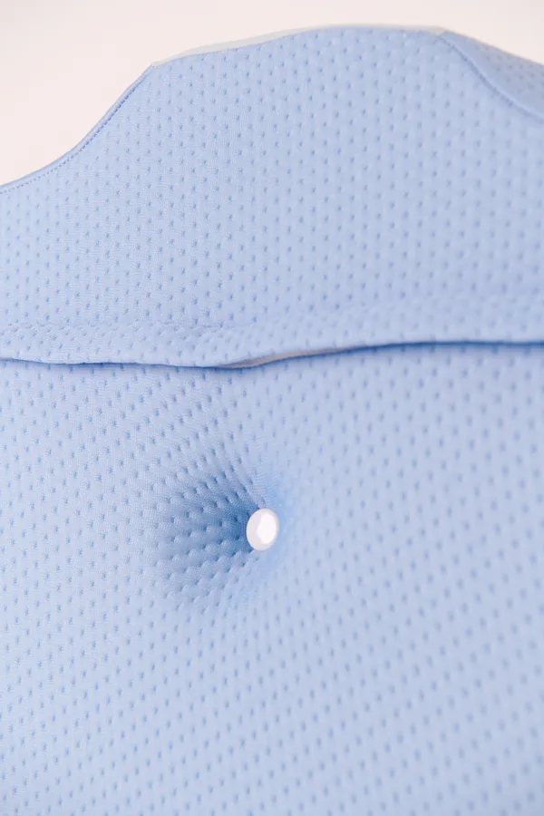 Close-up of the pillow's blue fabric surface and central contour