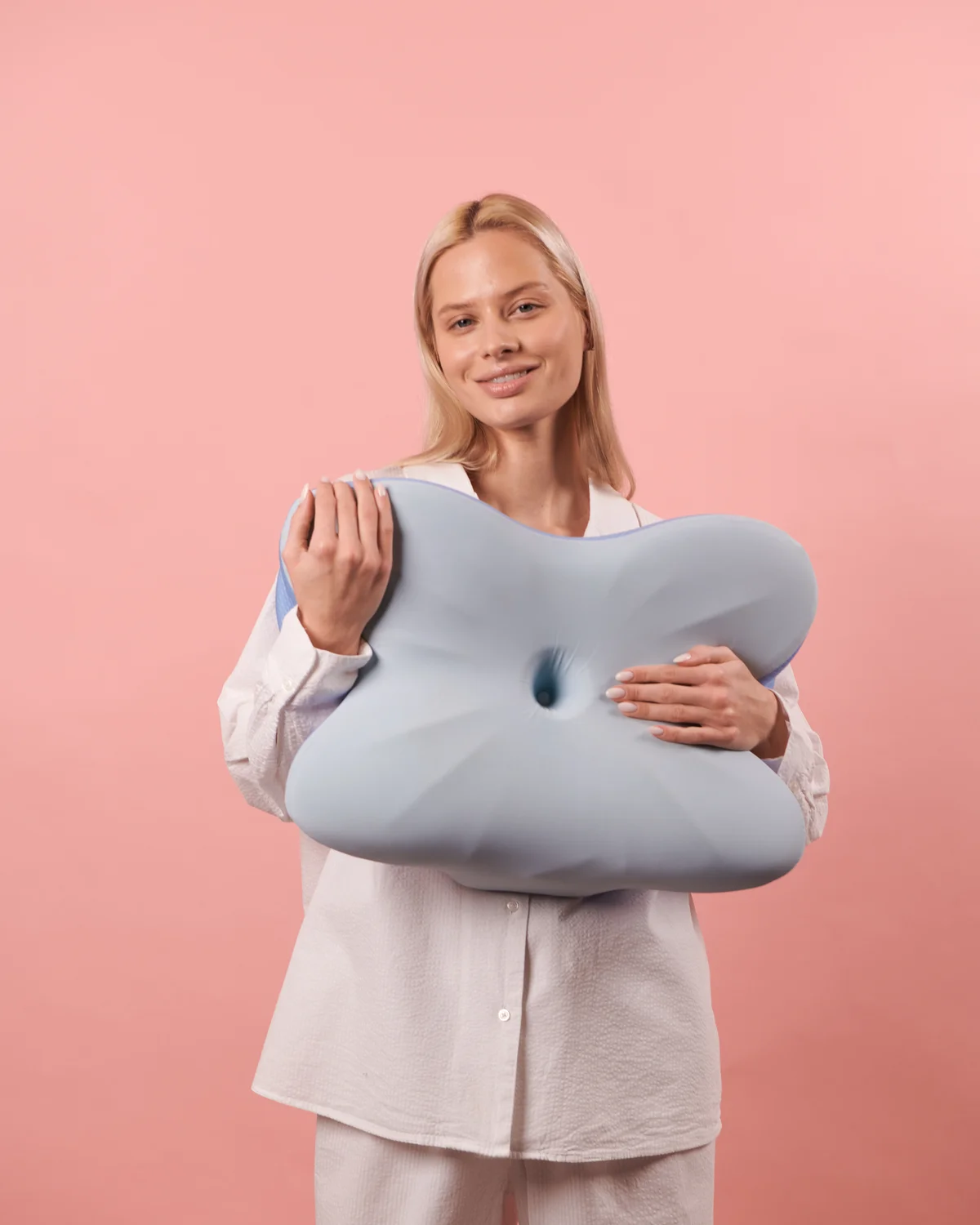 Person holding the pillow in a studio